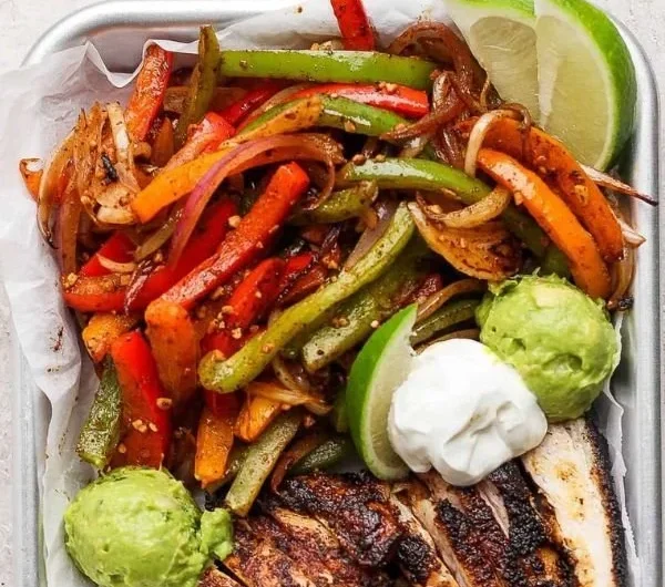 Sizzling Blackstone chicken fajitas with colorful peppers and onions