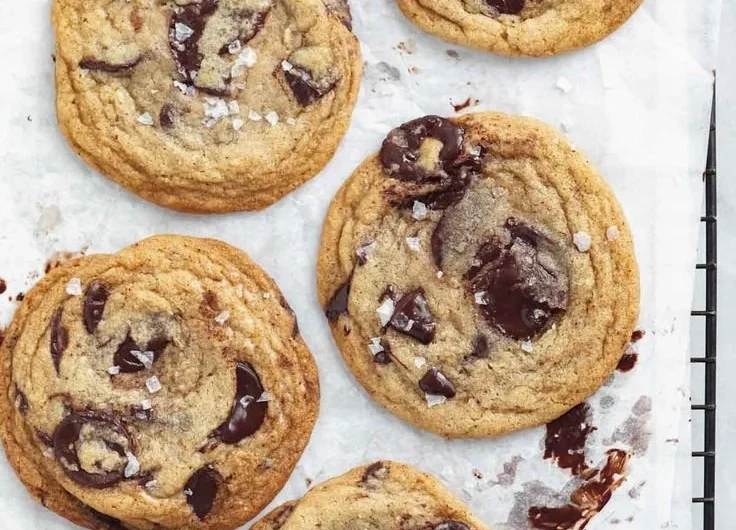 Delicious chewy chocolate chip cookies freshly baked on a cooling rack