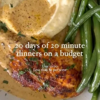 Creamy chicken schnitzel served with a side of vegetables and lemon wedges.