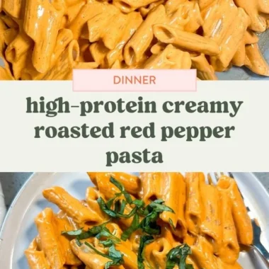 Creamy roasted red pepper pasta served in a bowl, topped with fresh herbs.