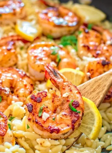 One-pot orzo with shrimp and feta topped with fresh herbs and lemon