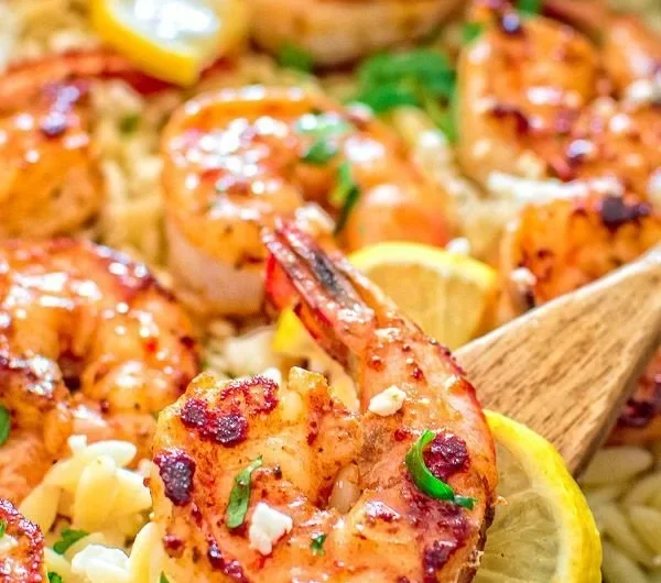 One-pot orzo with shrimp and feta topped with fresh herbs and lemon