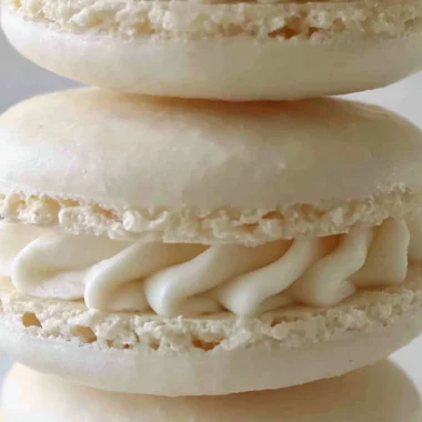 Aquafaba vegan macarons in various colors on a white plate