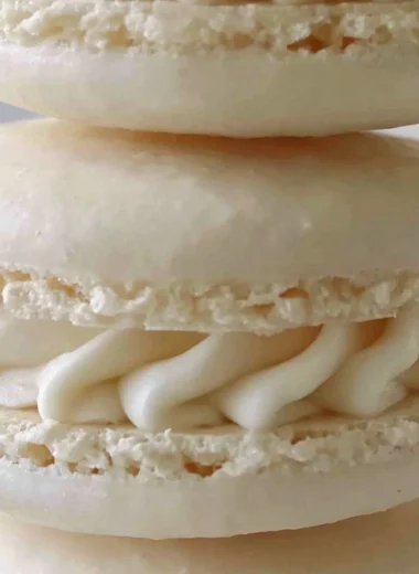 Aquafaba vegan macarons in various colors on a white plate
