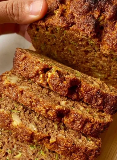 Delicious slice of best zucchini bread on a wooden table.
