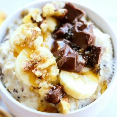 Bowl of Chunky Monkey Overnight Oats topped with banana slices and chocolate chips