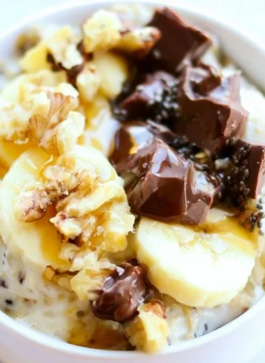 Bowl of Chunky Monkey Overnight Oats topped with banana slices and chocolate chips