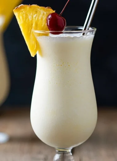 Classic Piña Colada cocktail garnished with pineapple and cherry
