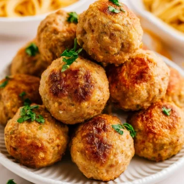 Cozy air fryer turkey meatballs served with marinara sauce.
