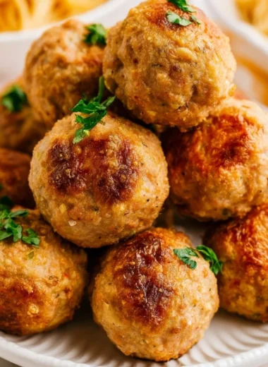 Cozy air fryer turkey meatballs served with marinara sauce.