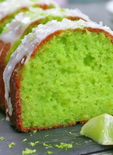 Cozy Key Lime Poke Cake topped with creamy frosting and lime zest