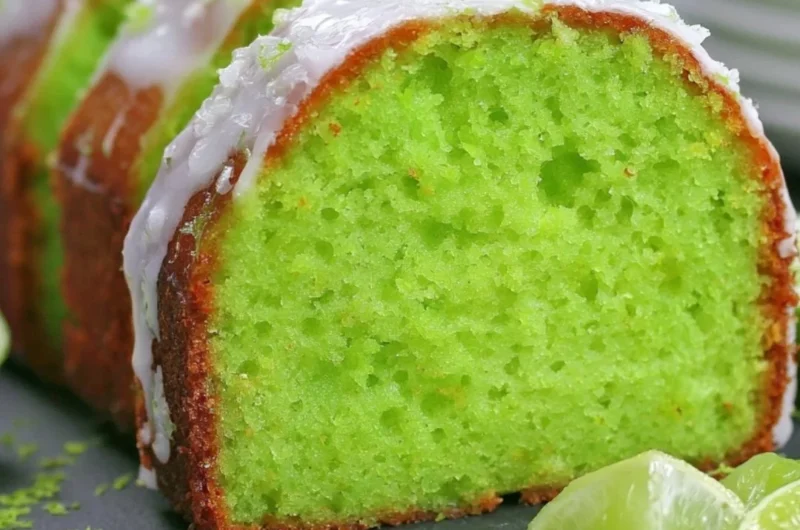 Cozy Key Lime Poke Cake topped with creamy frosting and lime zest