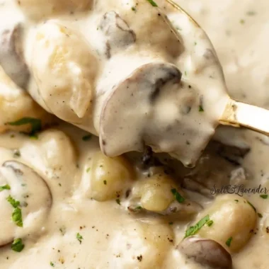 Plate of creamy Boursin Gnocchi topped with herbs and Parmesan cheese