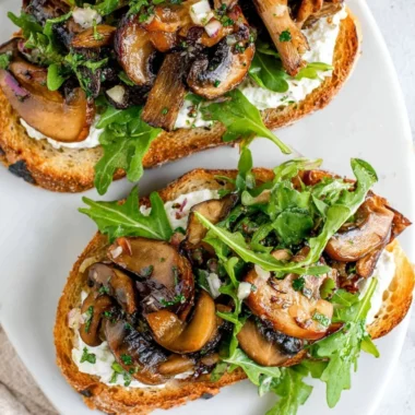 Creamy mushroom toast topped with fresh herbs on a rustic bread slice.