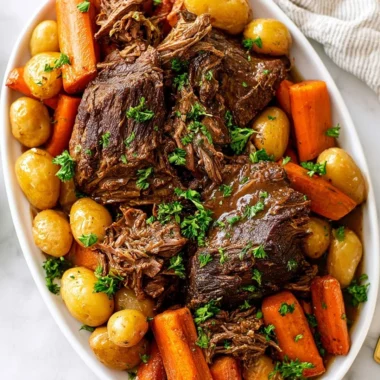 Delicious Crock Pot pot roast served with vegetables on a plate.
