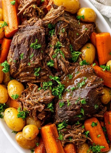 Delicious Crock Pot pot roast served with vegetables on a plate.