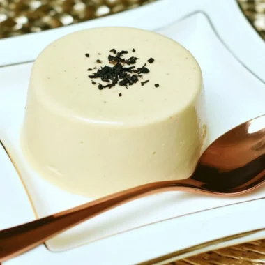 Earl Grey Panna Cotta dessert topped with tea leaves and lemon zest