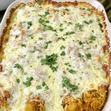 Easy dump and bake queso chicken with rice dish ready to serve.