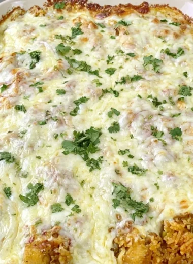 Easy dump and bake queso chicken with rice dish ready to serve.
