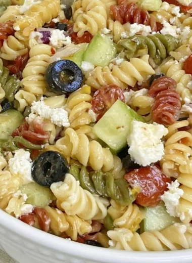 Bowl of easy Italian Pasta Salad with colorful vegetables and dressing