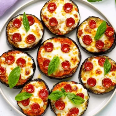 Delicious mini eggplant pizza topped with cheese and herbs