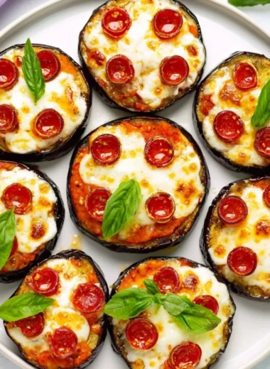 Delicious mini eggplant pizza topped with cheese and herbs