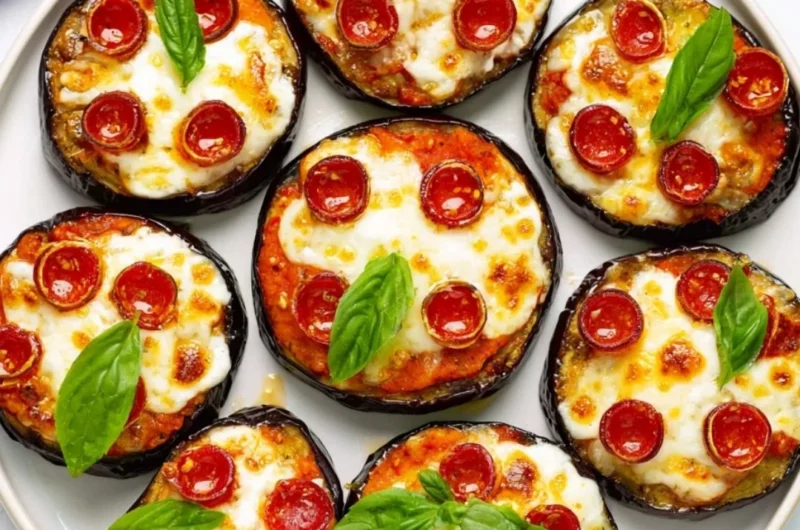 Delicious mini eggplant pizza topped with cheese and herbs
