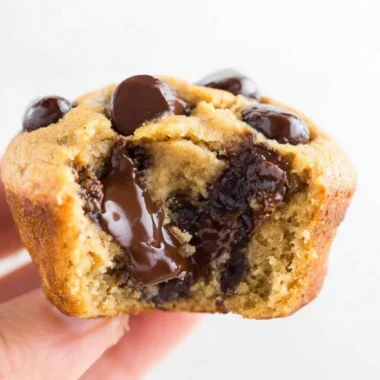 Delicious flourless peanut butter banana muffins topped with sliced bananas.