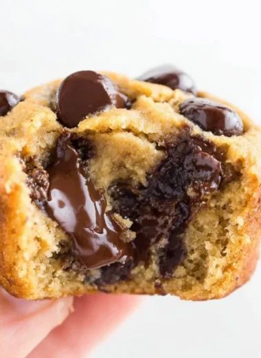 Delicious flourless peanut butter banana muffins topped with sliced bananas.