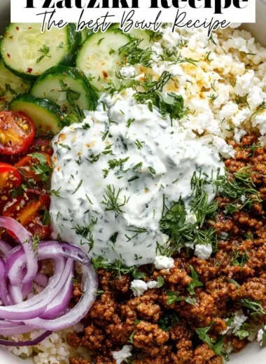 Healthy Greek Ground Beef Bowl topped with Tzatziki sauce and fresh veggies