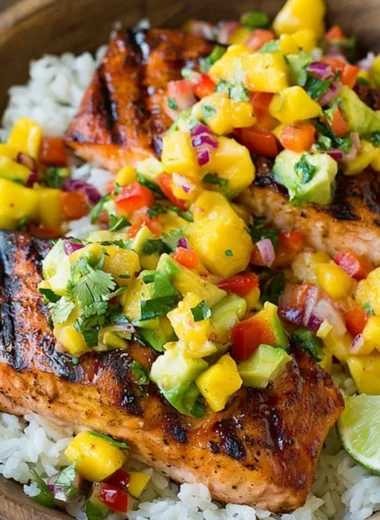 Grilled salmon with mango salsa on a bed of coconut rice.