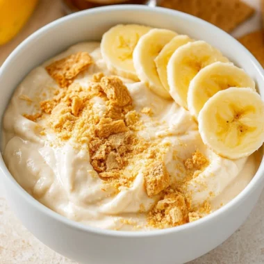 Healthy high protein banana pudding bowl topped with fresh bananas and nuts