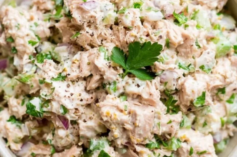 A healthy bowl of tuna salad with fresh vegetables and dressing