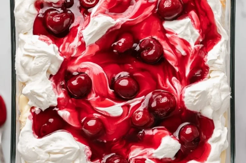 Slices of Heaven on Earth Cake with creamy layers and garnished with berries.