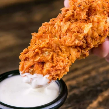Plate of homemade buttermilk chicken tenders served with dipping sauce