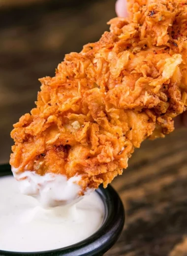 Plate of homemade buttermilk chicken tenders served with dipping sauce
