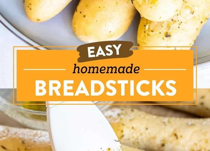 Homemade garlic herb breadsticks arranged on a plate, ready to serve.