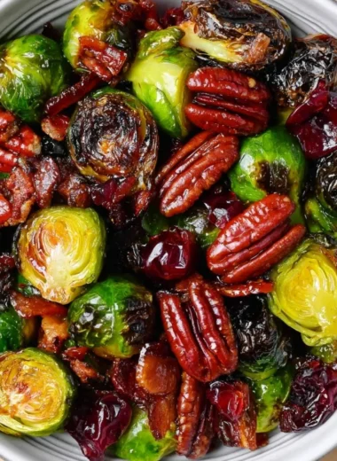 Plate of Roasted Brussels Sprouts with bacon, toasted pecans, and cranberries.