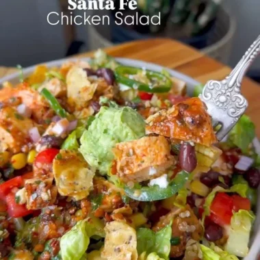 Colorful Santa Fe Salad with greens, beans, and spices in a bowl.