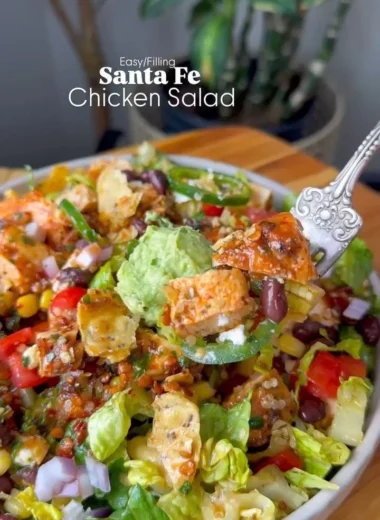 Colorful Santa Fe Salad with greens, beans, and spices in a bowl.