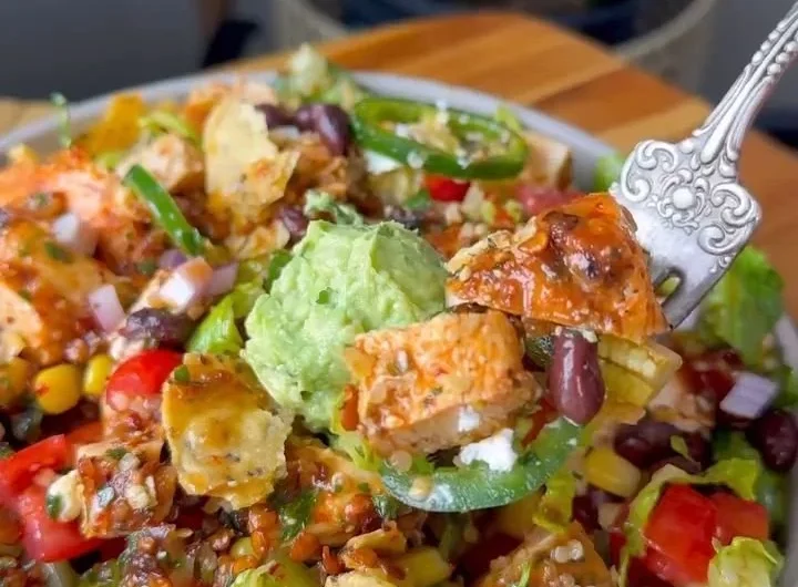 Colorful Santa Fe Salad with greens, beans, and spices in a bowl.