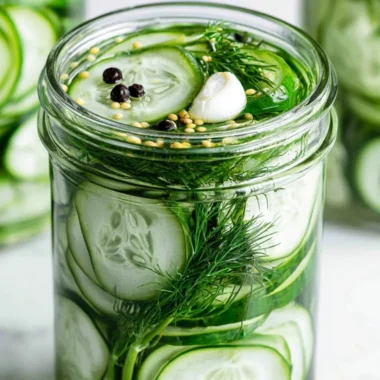 Homemade super easy refrigerator dill pickles in a glass jar on a wooden table