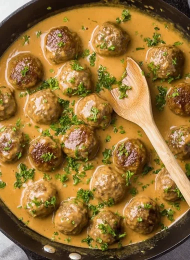 Delicious Swedish meatballs served with creamy sauce and lingonberry jam