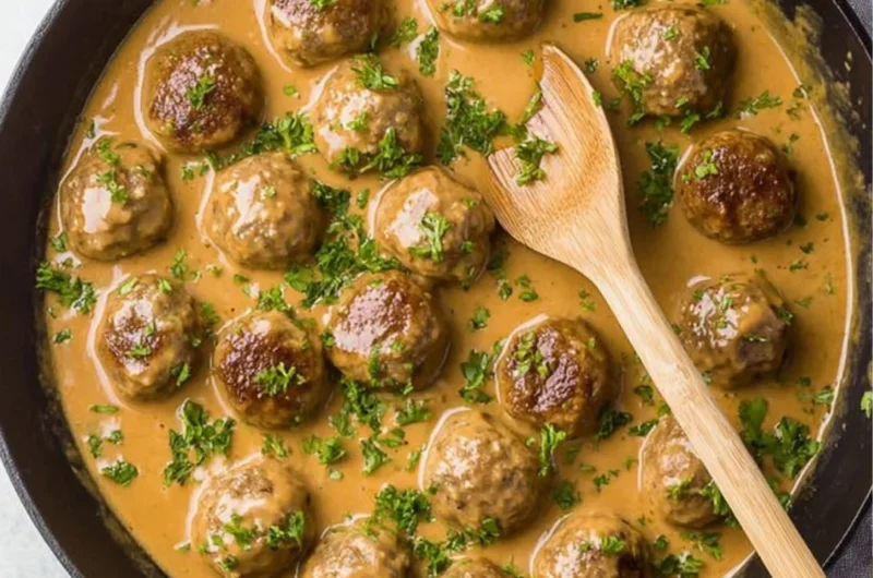 Delicious Swedish meatballs served with creamy sauce and lingonberry jam