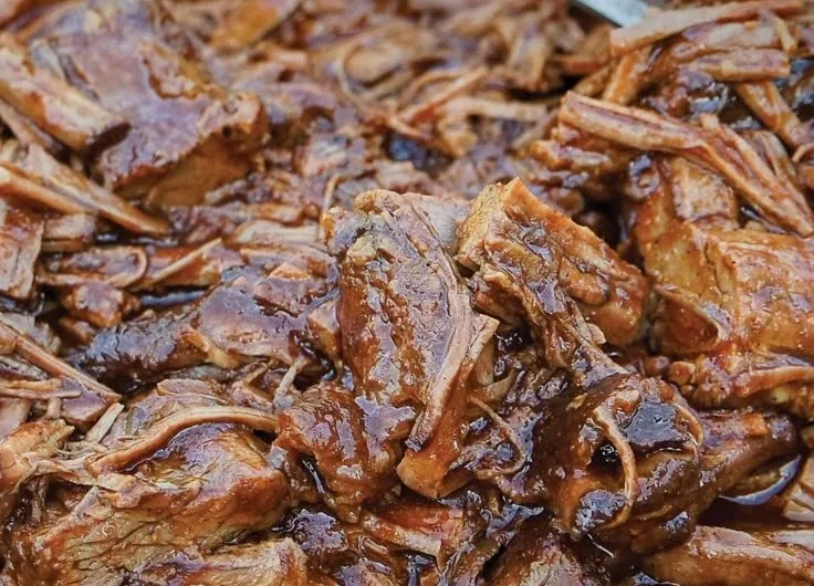 Texas Cola Shredded Beef Brisket served with a side of barbecue sauce