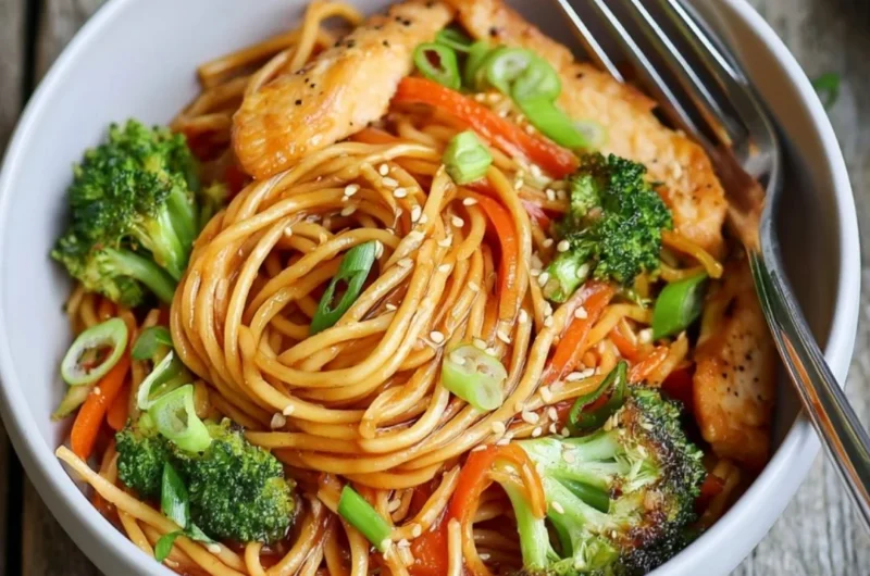 15-minute chicken stir fry noodles served in a bowl with vegetables.