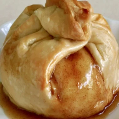 Delicious apple dumplings served warm with cinnamon and sauce
