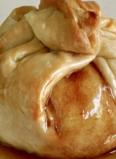 Delicious apple dumplings served warm with cinnamon and sauce