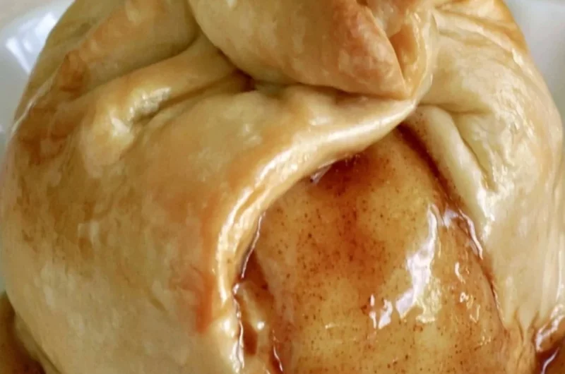 Delicious apple dumplings served warm with cinnamon and sauce