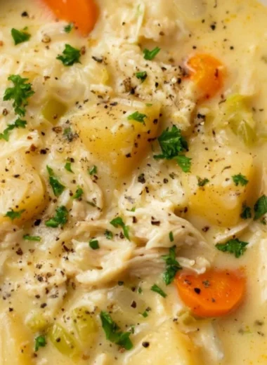 Delicious Chicken Pot Pie Soup in a bowl, garnished with parsley.